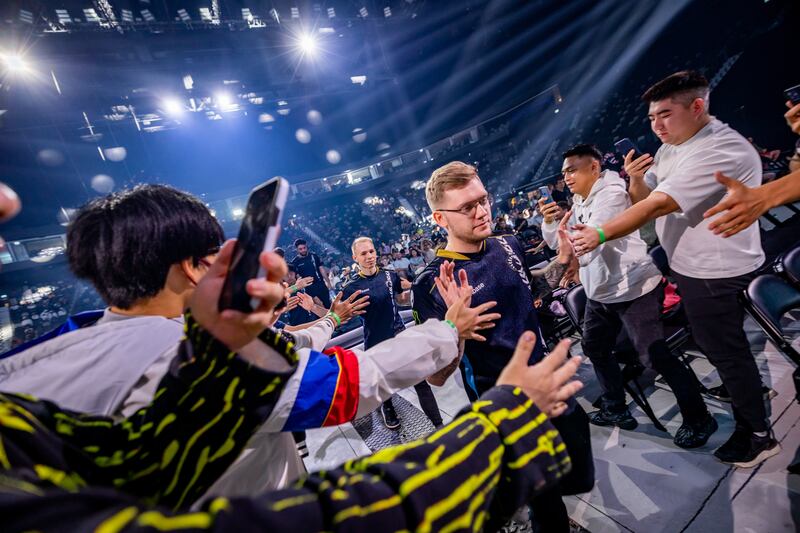 Team Liquid enter the stage while high-fiving fans
