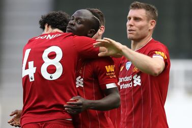 Liverpool's Senegalese striker Sadio Mane (R) is congratulated by teammates after scoring a goal during the English Premier League football match between Newcastle United and Liverpool at St James' Park in Newcastle-upon-Tyne, north east England on July 26, 2020. RESTRICTED TO EDITORIAL USE. No use with unauthorized audio, video, data, fixture lists, club/league logos or 'live' services. Online in-match use limited to 120 images. An additional 40 images may be used in extra time. No video emulation. Social media in-match use limited to 120 images. An additional 40 images may be used in extra time. No use in betting publications, games or single club/league/player publications. / AFP / POOL / OWEN HUMPHREYS / RESTRICTED TO EDITORIAL USE. No use with unauthorized audio, video, data, fixture lists, club/league logos or 'live' services. Online in-match use limited to 120 images. An additional 40 images may be used in extra time. No video emulation. Social media in-match use limited to 120 images. An additional 40 images may be used in extra time. No use in betting publications, games or single club/league/player publications.