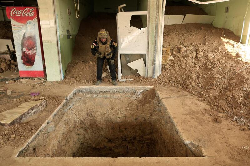 An Iraqi special forces soldier looks down the entrance of a tunnel used by ISIS fighters inside a restaurant in Bazwaya, east of Mosul. Reuters