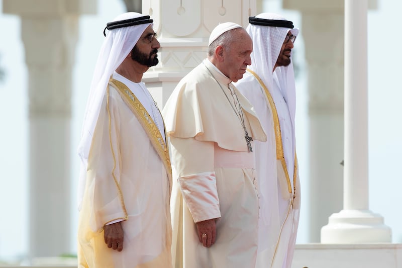 ABU DHABI, UNITED ARAB EMIRATES - February 4, 2019: Day two of the UAE papal visit - (L-R) HH Sheikh Mohamed bin Rashid Al Maktoum, Vice-President, Prime Minister of the UAE, Ruler of Dubai and Minister of Defence, His Holiness Pope Francis, Head of the Catholic Church, and HH Sheikh Mohamed bin Zayed Al Nahyan, Crown Prince of Abu Dhabi and Deputy Supreme Commander of the UAE Armed Forces, stand for a national anthem during an official reception at the Presidential Palace. 

( Ryan Carter / Ministry of Presidential Affairs )
---