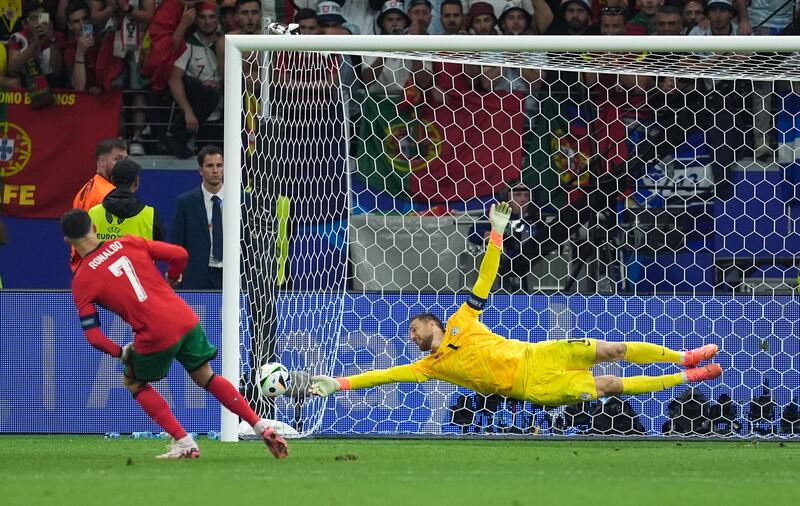 Cristiano Ronaldo scores Portugal's first penalty in the shoot-out. PA 