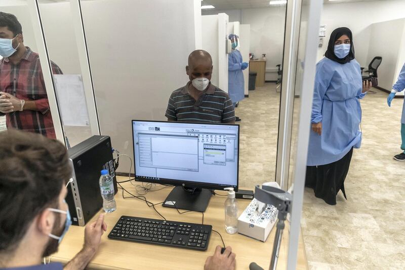 ABU DHABI, UNITED ARAB EMIRATES. 16 APRIL 2020. COVID-19 Testing station in Al Mussafah. A man registers for his test. (Photo: Antonie Robertson/The National) Journalist: Haneen Dajani. Section: National.