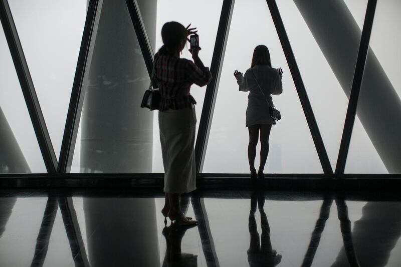 Visitors look at the view from the top floor of the Guangzhou Tower in Guangzhou, China. Guangzhou, formerly known as Canton, is the capital of the province of Guangdong in southern China and the main manufacturing hub of the Pearl River Delta.  EPA / STR.