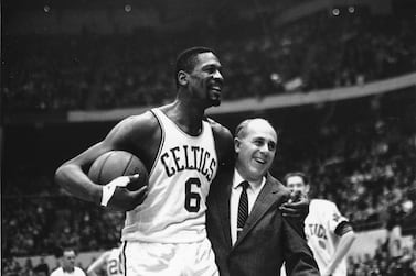 FILE - Bill Russell, left, star of the Boston Celtics is congratulated by coach Arnold "Red" Auerbach after scoring his 10,000th point in the NBA game against the Baltimore Bullets in Boston Garden on Dec.  12, 1964.  The NBA great Bill Russell has died at age 88.  His family said on social media that Russell died on Sunday, July 31, 2022.  Russell anchored a Boston Celtics dynasty that won 11 titles in 13 years.  (AP Photo / Bill Chaplis, file)