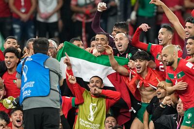 Morocco's players with the Palestinian flag after beating Spain. AP