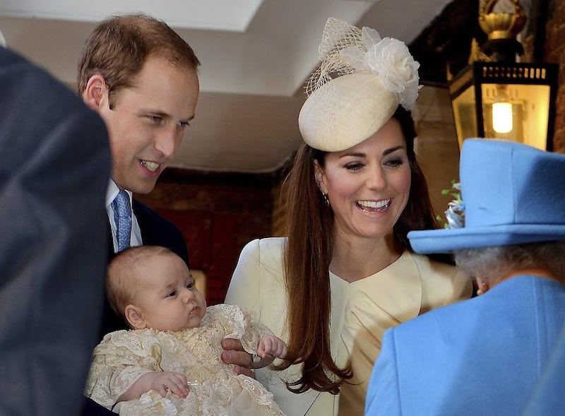 Britain's Queen Elizabeth II, right, speaks with Prince William and Duchess Kate with their son Prince George John Stillwell/ AP