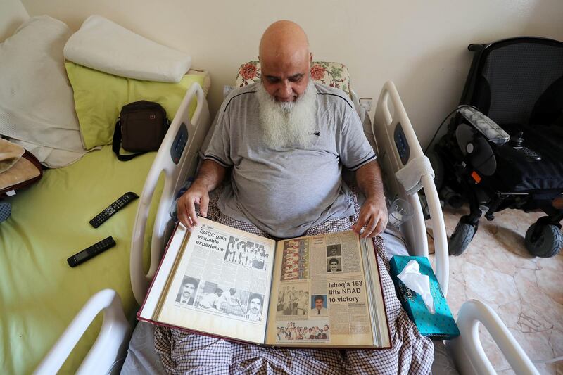 ABU DHABI,  UNITED ARAB EMIRATES , JUNE 17 – 2019 :- Mohammed Ishaq a player in the UAE's 1996 World Cup side, who is now wheelchair bound showing newspapers clipping at his home in Abu Dhabi. He is on wheelchair since a car crash in 2009. ( Pawan Singh / The National ) For Sport. Story by Paul