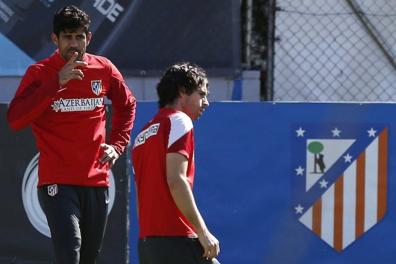 Diego Costa, left, and Tiago Mendes, right, shown during Atletico Madrid's training session for their match with Barcelona on Saturday. Javier Lizon / EPA / May 16, 2014