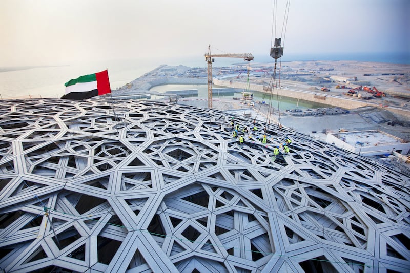 The last piece of the outer roof is put into place at the Louvre Abu Dhabi construction site on Saadiyat Island. Christopher Pike / The National