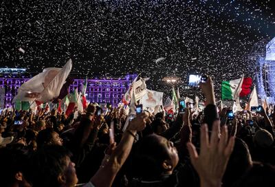 Supporters of the presidential candidate for the "Juntos haremos historia" coalition, Andres Manuel Lopez Obrador, celebrate at the Zocalo square in Mexico City, after getting the preliminary results of the general elections on July 1, 2018.  Anti-establishment leftist Andres Manuel Lopez Obrador won Mexico's presidential election Sunday by a large margin, according to exit polls, in a landmark break with the parties that have governed for nearly a century. / AFP / Guillermo Arias
