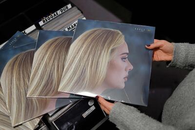 A member of staff sorts copies of the new album from British singer-songwriter Adele, '30' in Sister Ray record store in London. AFP