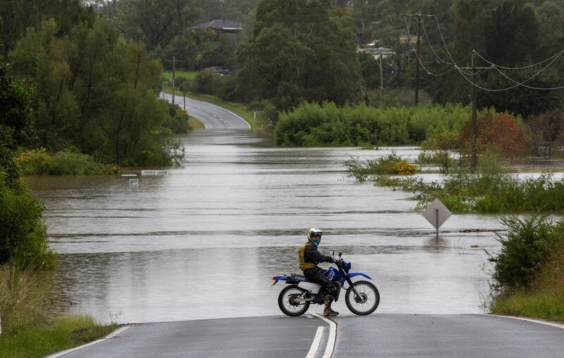 A motorcyclist is blocked by a flooded road at Old Pitt Town, north-west of Sydney, Australia. The country's most populous state of New South Wales on Sunday issued ordered more evacuations following the worst flooding in decades. AP Photo