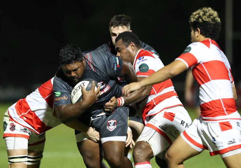 Dubai Exiles' Moeneeb Galant is tackled by Dubai Tigers players during the UAE Premiership game.