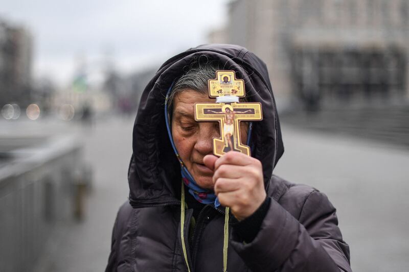 A Ukrainian woman prays on Independence Square in Kiev on Thursday. AFP