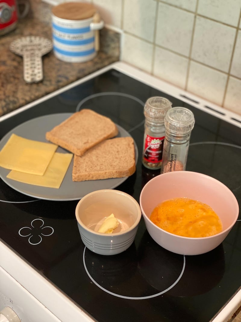 The ingredients you need for the TikTok one pan egg sandwich: two slices of bread, two beaten eggs, a knob of butter, salt, pepper and optional slices of cheese. Farah Andrews / The National 