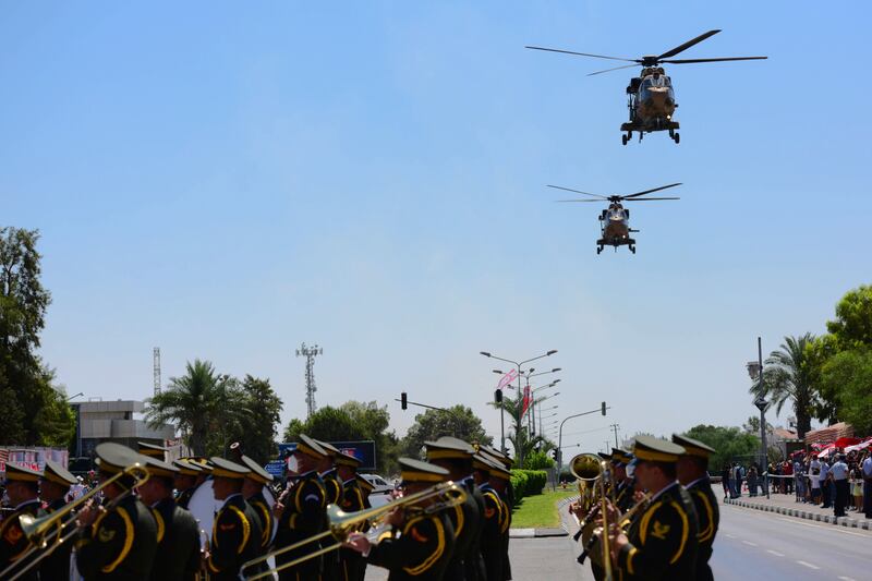 Mr Erdogan reviews a guard of honour with the Turkish Cypriot leader. Reuters