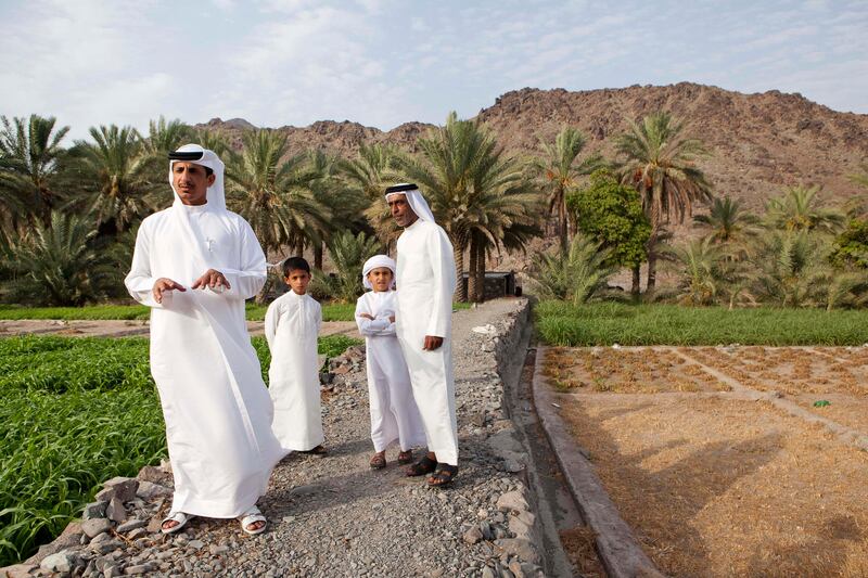 June 17, Khalifa Al Litbi (Far left) explains the traditional way of life on an Emirate farm in Wadi Al Tuwa. Behnd him stands Khalfan Al Dhagmani (Far Right), Mohammed Khalifa (second left and Saeed Al Kitbi (Second right). June 1, Ras Al Khaimah, United Arab Emirates. (Photo: Antonie Robertson/ The National)