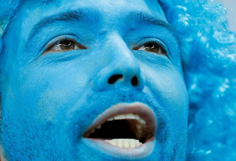 An Uruguay fan covered in blue cheers prior to his team's Copa America Group C soccer match against Ecuador at the Mineirao stadium in Belo Horizonte, Brazil.  AP