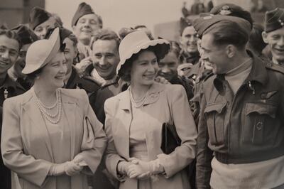 The queen and her parents meet servicemen in a photograph in the exhibition 'Crown And Conflict - Portraits of a Queen in Wartime'. Victoria Pertusa / The National