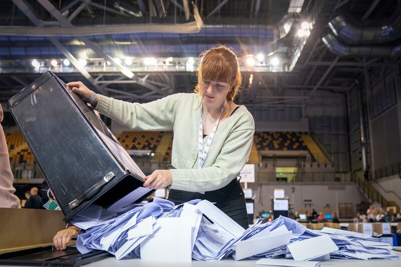Ballot boxes are opened at the Glasgow City Council building in Scotland. PA