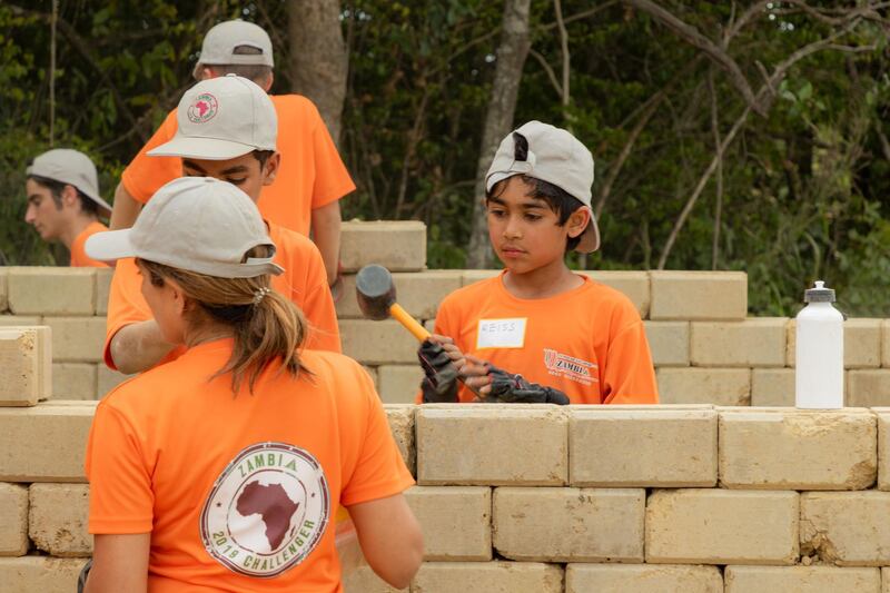 Dads and children from the UAE group worked together to help extend a school in Zambia, adding four classrooms and a solar powered computer lab. Courtesy, Fathers And Kids Camping