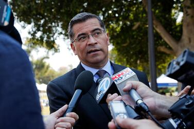 California Attorney General Xavier Becerra talks to reporters after a news conference at UCLA. President-elect Joe Biden has picked Mr Becerra to be his health secretary. AP Photo