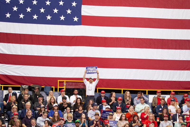 A members of the crowd holds a 'Drain the Swamp' sign while waiting for Donald Trump to speak at a 'Make America Great Again' rally in Chattanooga, Tennessee. EPA