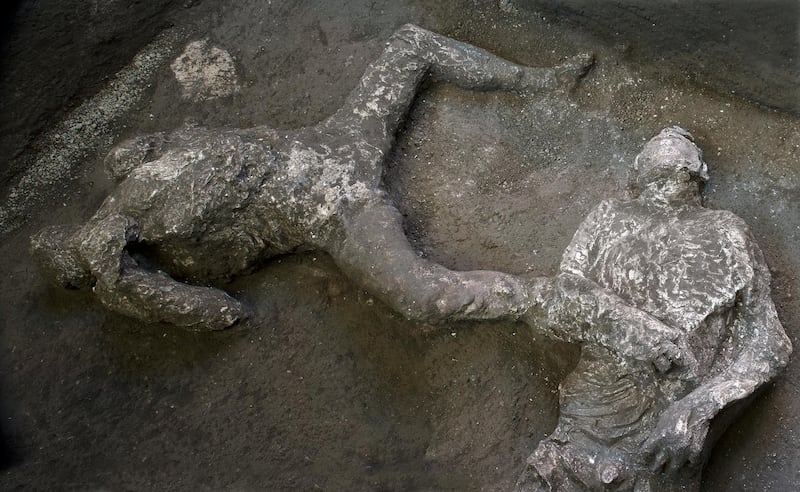 The casts of what are believed to have been a rich man and his male slave fleeing the volcanic eruption of Vesuvius nearly 2,000 years ago, are seen in what was an elegant villa on the outskirts of the ancient Roman city of Pompeii destroyed by the eruption in 79 A.D. AP