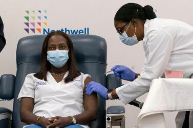 Sandra Lindsay, left, a nurse at Long Island Jewish Medical Centre, became the first person in the US to be vaccinated against Covid-19 on December 14. AP