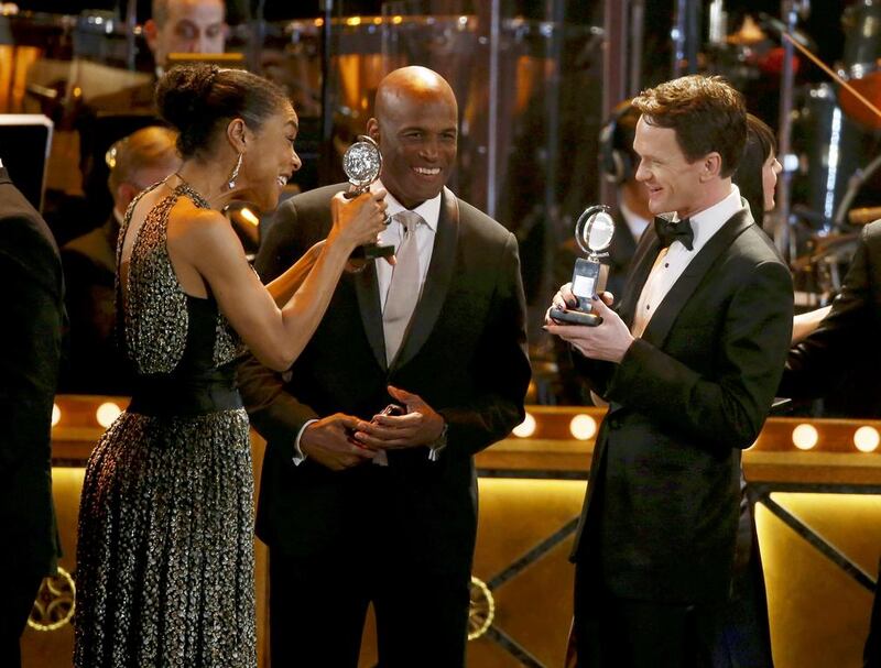 Sophie Okonedo, left, and Neil Patrick Harris, right, congratulate each other as the 2014 Tony Award winners celebrate onstage during the closing of the American Theatre Wing’s 68th annual Tony Awards. Carlo Allegri / Reuters