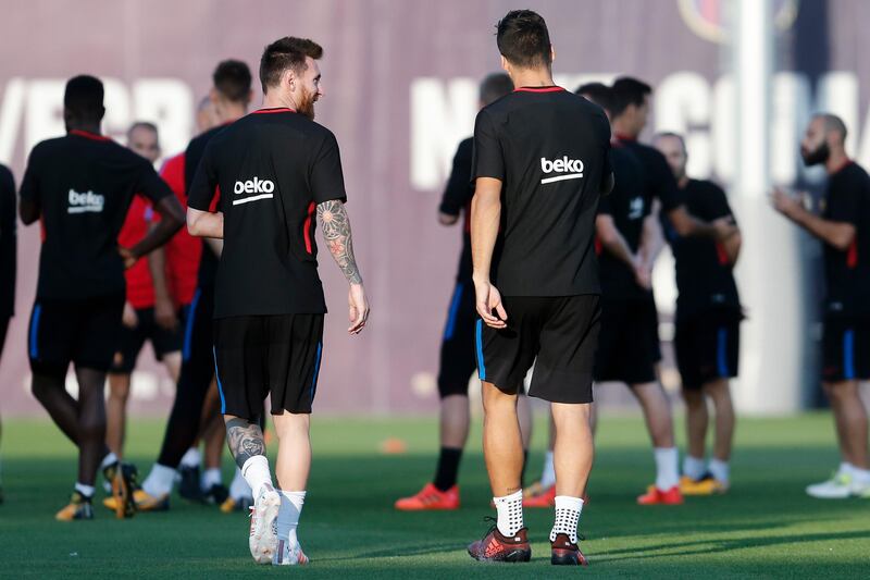 Lionel Messi, left, and Luis Suarez arrive for a training session at the Joan Gamper Sports Center as Barcelona prepare for the Primera Liga clash against Atletico Madrid. Pau Barrena / AFP