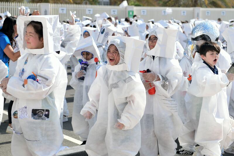 Pupils at Repton Abu Dhabi cheer after breaking the Guinness world record for the largest gathering of people dressed as astronauts. A total of 940 mini astronauts gathered as the Reem Island school. Khushnum Bhandari / The National