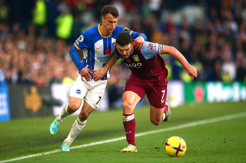 John McGinn of Aston Villa tangles with Solly March of Brighton. Getty 