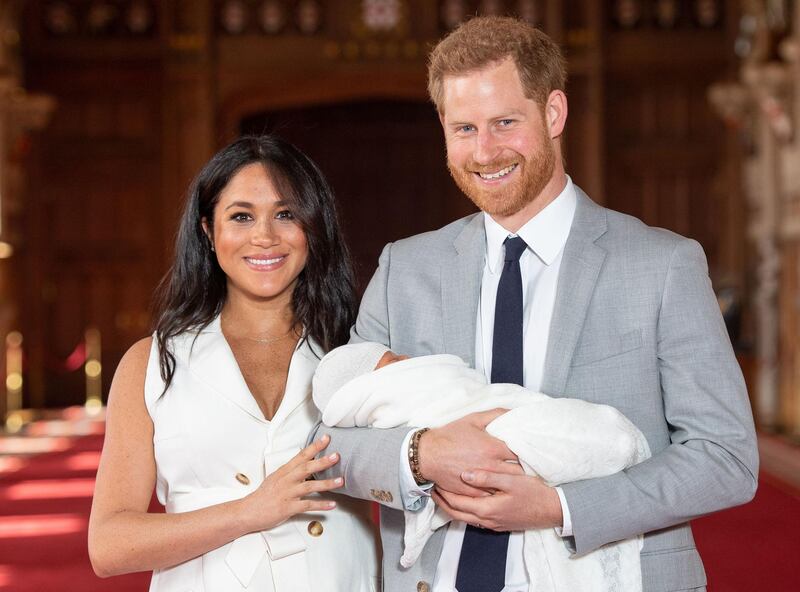 (FILES) In this file photo taken on May 08, 2019 Britain's Prince Harry, Duke of Sussex (R), and his wife Meghan, Duchess of Sussex, pose for a photo with their newborn baby son, Archie Harrison Mountbatten-Windsor, in St George's Hall at Windsor Castle. Prince Harry and his wife Meghan's new home in Windsor cost £2.4 million ($3.05 million, 2.7 million euros) of taxpayers' money to renovate, royal accounts showed on June 25, 2019, prompting criticism from anti-monarchy campaigners. / AFP / POOL / Dominic Lipinski
