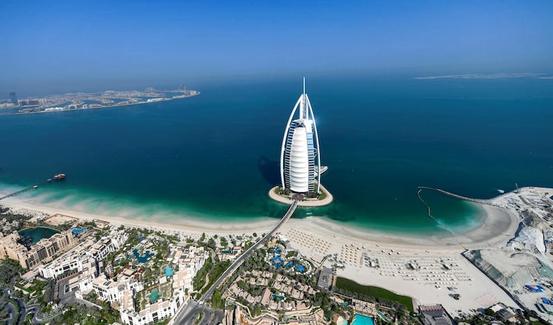 This picture taken on July 8, 2020 shows an aerial view of the Burj al-Arab hotel in the Gulf emirate of Dubai, during a government-organised helicopter tour. (Photo by KARIM SAHIB / AFP)