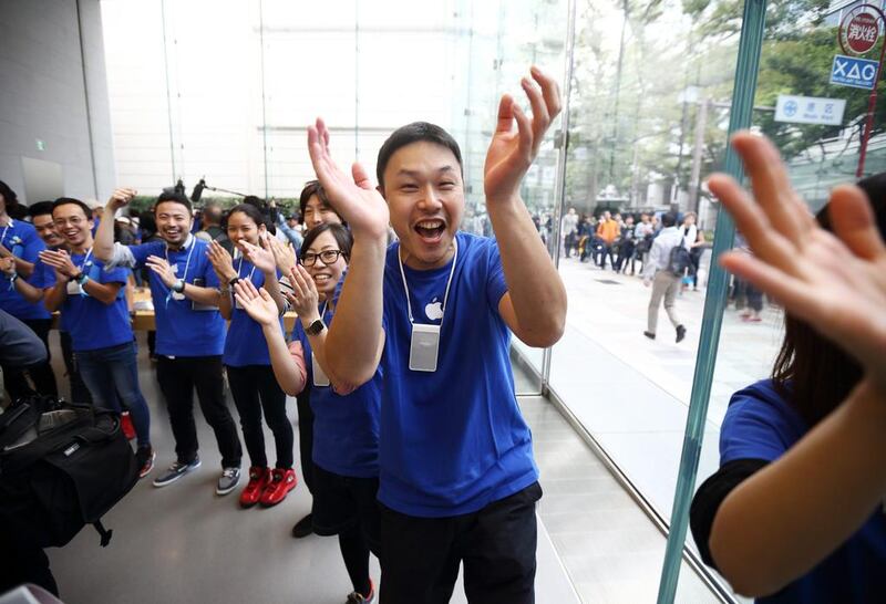 Employees cheer before the launch of Apple Inc’s iPhone 6 and iPhone 6 Plus at the company’s Omotesando store in Tokyo. Tomohiro Ohsumi / Bloomberg