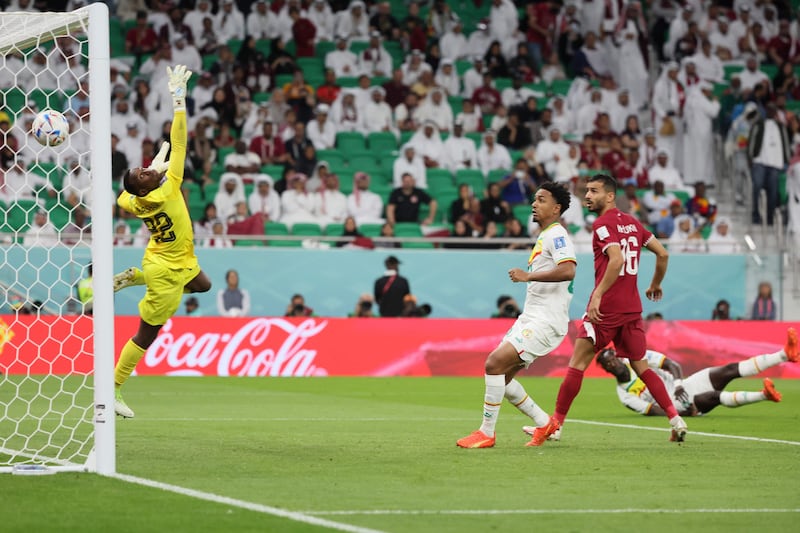 Qatar goalkeeper Meshaal Barsham is beaten by the grounded Famara Diedhiou's header that put Senegal two up. AFP