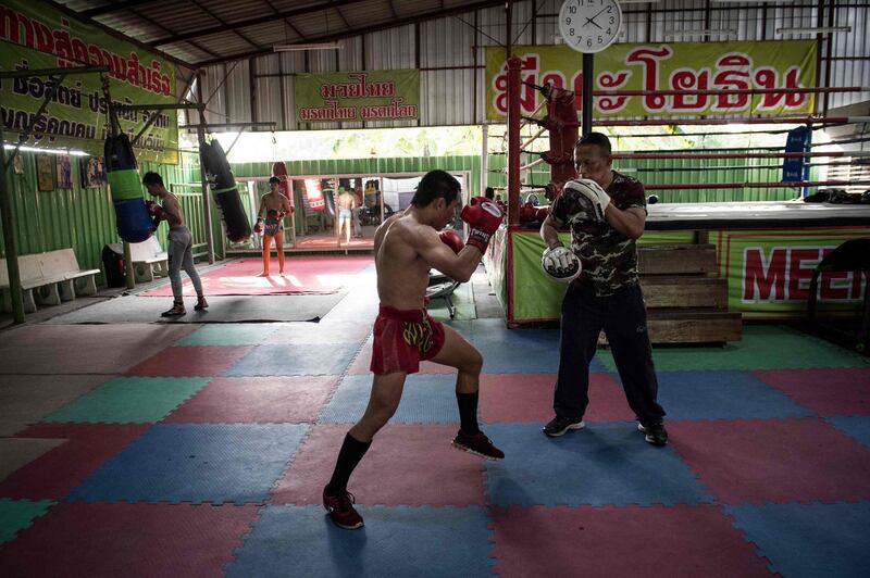 World Boxing Council (WBC) mini-flyweight champion, Wanheng Menayothin (C), doing pad work with his trainer during a training session in Bangkok. Lillian Suwanrumpha / AFP