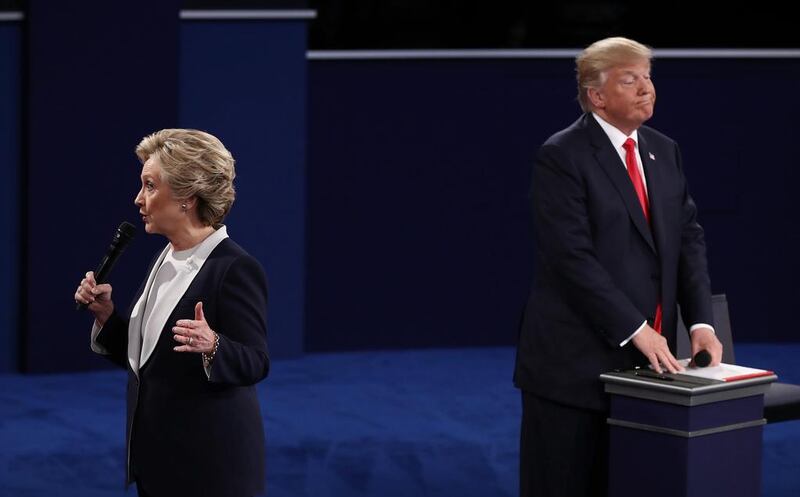 Democratic presidential nominee former Secretary of State Hillary Clinton (L) speaks as Republican presidential nominee Donald Trump listens during the town hall debate at Washington University. Win McNamee / Getty Images