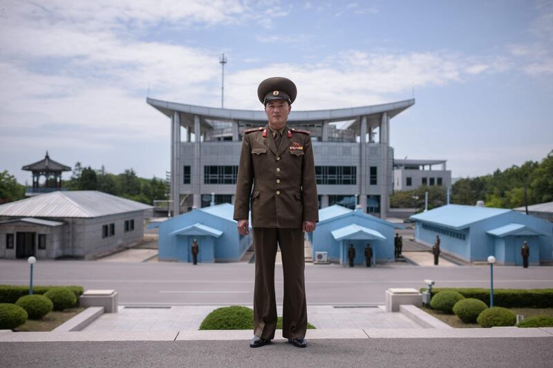 In a photo taken on June 2, 2017 Korean People's Army (KPA) soldier Lieutenant Kim poses for a portrait before the military demarcation line at the truce village of Panmunjom within the Demilitarized Zone (DMZ) separating North and South Korea.

North Korean leader Kim Jong Un on April 27 will have a historic summit with the South's president Moon Jae-in -- a major setpiece of the diplomatic whirlwind over the flashpoint peninsula as the young leader prepares for a highly-anticipated meeting with Donald Trump. 
 / AFP PHOTO / Ed JONES / To go with SKorea-NKorea-politics-diplomacy, ADVANCER by Jung Hawon