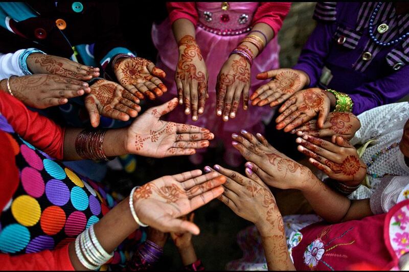 Easter handouts: Christian girls show their hands decorated with Bangles and painted with Henna paste as they celebrate Easter after a mass at in a Christian neighbourhood in Islamabad, Pakistan. Muhammed Muheisen / AP Photo