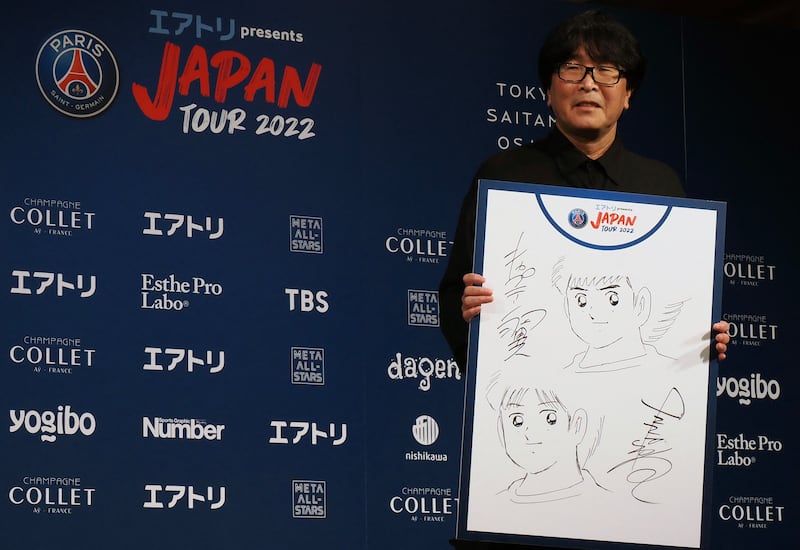 Yoichi Takahashi, Japanese manga artist known for his work of ‘Captain Tsubasa’, displays his illustration. AFP