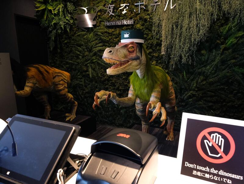 A robot dinosaur wearing a bellboy hats welcomes guests from the front desk at the Henn-na Hotel.  AFP