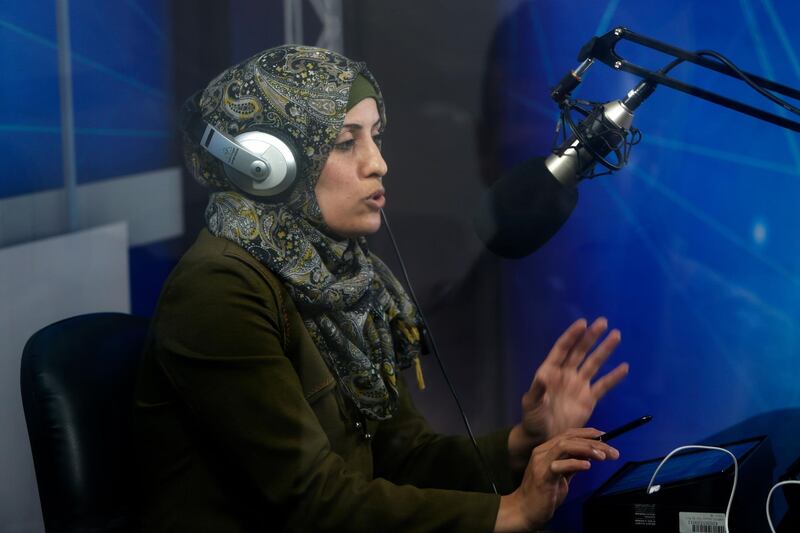 A Palestinian teacer broadcasts a lessen from an educational radio station, in order for students to follow through their mobile telephones at home, during their isolation period in a bid to prevent the spread of the novel coronavirus, in Gaza City.  AFP