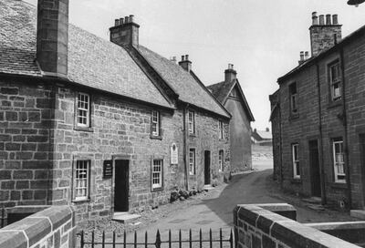 A street in Dumfries showing Robert Burns' cottage on left, in much the same state as when he lived in it, 1946.  Burns died here at the age of 37. Original Publication : Picture Post - 4154 - In Praise of Robert Burns - pub. 27th July 1946.  (Photo by Haywood Magee/Picture Post/Getty Images)