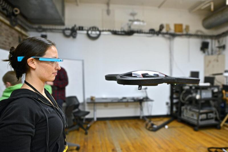 A participant controls an AR Drone toy drone using Google glasses at a Nodecopter, an event where people form small groups to program toy drones. Kike Calvo via AP Images