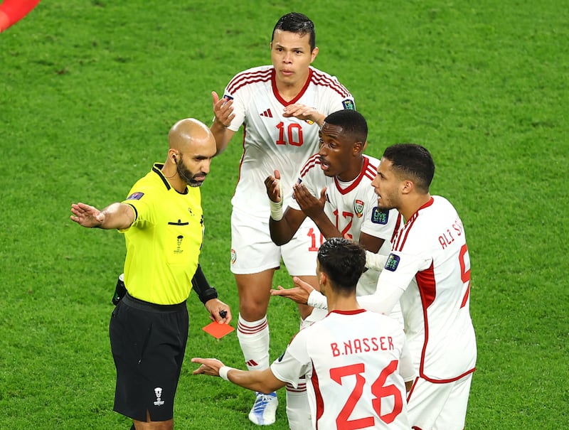 UAE's Khalifa Al Hammadi is shown a red card by referee Ahmed Al Ali. Reuters