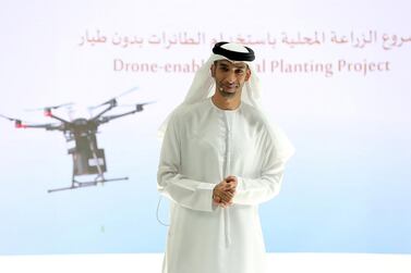Dr Thani Al Zeyoudi, Minister of Climate Change and Environment, unveils plans for mangrove-planting drones to boost the country's coastline at an event held at Emirates Towers in Dubai. Pawan Singh/The National