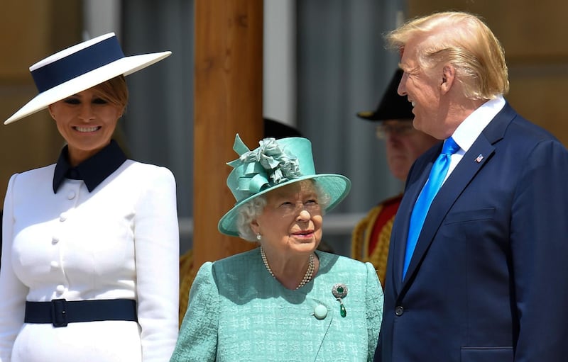 Britain's Queen Elizabeth II (C) speaks with US President Donald Trump (R) as US First Lady Melania Trump (L) smiles during a welcome ceremony at Buckingham Palace in central London on June 3, 2019, on the first day of the US president and First Lady's three-day State Visit to the UK.  AFP