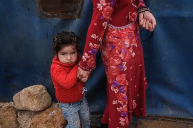 A displaced Syrian girl holds her mother's hand as they wait for aid at Gemmura camp in Sarmada district, on the outskirts of Idlib, Syria, 25 November 2021 (issued 27 November 2021).  Since 2011, the Turkish Red Crescent (or Kizilay) has delivered 55 thousand trucks of aid materials into Syria.  Some 111 thousand tents, eight million food parcels, 116 million bread parcels, 2. 7 million hygiene kits, 2. 5 million stationery materials, 65 million clothing and blankets have been distributed.  Around 20,000 packets of bread are produced daily in Turkish Red Crescent's bakeries and delivered to those in need.  Aid materials sent in this context have so far amounted to 3. 5 billion Turkish lira (about 281 million US dollar).  There are 12 camps and 14 orphanages in the Idlib region.  In the Mashat Ruhin region of Idlib's Sarmada district, the Turkish Red Crescent has planned to build 1,228 brick houses, of which, more than 748 have been completed.  According to the United Nations UN), 13. 4 million people inside Syria are in need of some form of humanitarian assistance, including six million in acute need.  More than 12 million were struggling to find enough food each day and half a million children were chronically malnourished.   EPA / SEDAT SUNA